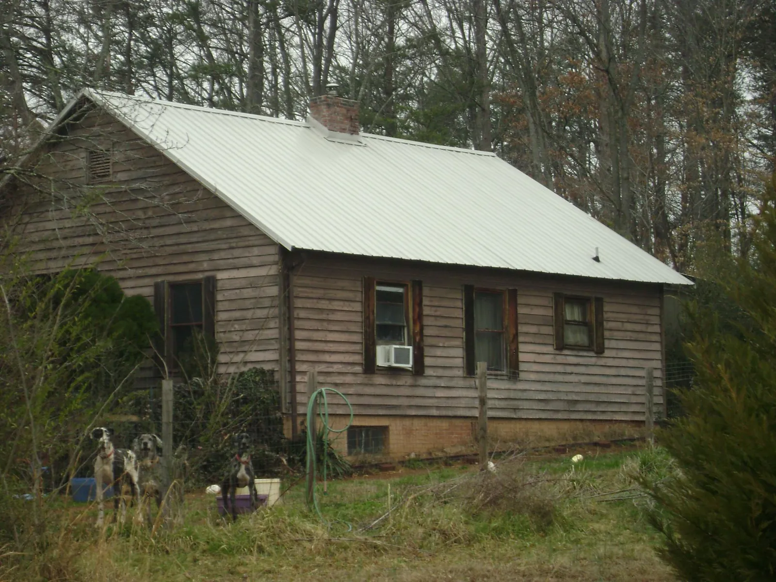 White metal roof on an old wood sided farmhouse, from a Metal Roof Installation job in Wayne